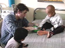 Houston takes an imprint of the hand of an Iraqi child dying of cancer in a Baghdad hospital.
